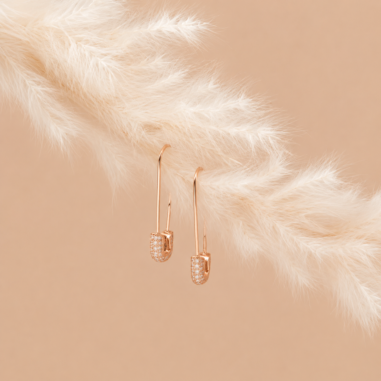 Rose gold earrings on a fur surface